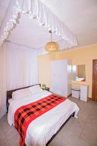 NarokEbony Mara的一间卧室配有一张带红色和黑色毯子的床
