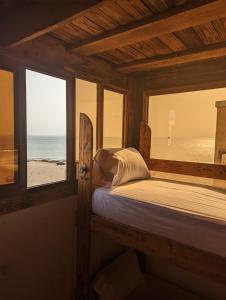 阿加迪尔darna surf house anza的一间卧室配有一张床,享有海滩美景