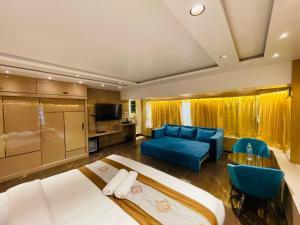 孟买Home2 Renaissance Club的酒店客房,设有两张床和一张蓝色的沙发