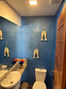 巴拉格兰德Condominio Viva Barra的蓝色的浴室设有卫生间和水槽