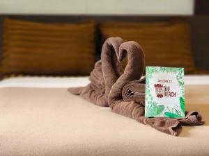 班泰Tiki Beach Koh Phangan的一条毛巾,形状像天鹅,在床上看书