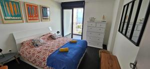 FleurimontL'appartement de l'Horizon - Plateau Cailloux的一间卧室配有一张床、一张书桌和一个窗户。