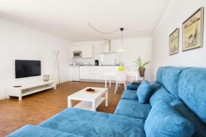 马赫Peñas Blancas的一间带蓝色沙发的客厅和一间厨房