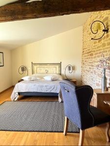 VinzellesLa côte des Blancs - Domaine viticole & maison d'hôtes的一间卧室配有一张床和一把椅子