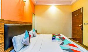 新德里FabExpress JP Palace的橙色墙壁间的一张床位