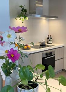 ZwevegemHotel - B&B PassaDia的厨房配有炉灶和一些鲜花