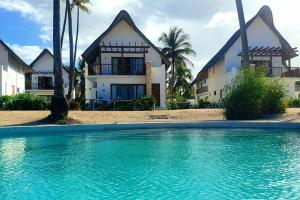 平圭Ocean Front Villa with pool, Zanzibar的房子前面的房子和游泳池