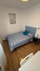 库列拉Piso Centro de Cullera的一间小卧室,配有一张带蓝色棉被的床