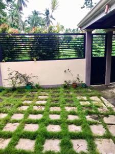 帕加迪安Pagadian City House Rental - Hidehouse的后院设有栅栏、草地和庭院