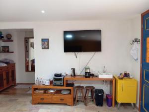 欧鲁普雷图Solar dos Reis Apartamento Topázio的一间设有一张桌子的房间,墙上配有电视