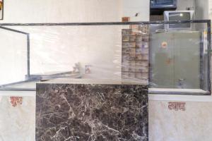 那格浦尔SPOT ON Hotel Sanskriti的玻璃展示盒,上面有黑色大理石台面
