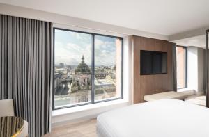 格拉斯哥AC Hotel by Marriott Glasgow的卧室设有大窗户,享有城市美景。