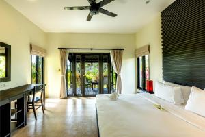 蔻立Phukhaolak Resort的卧室配有一张床、一张书桌和窗户。