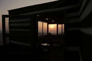 TaiyibaPlaza View Hostel的透过窗户可欣赏到日落美景的客房