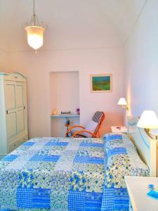 阿马尔菲Casa Vacanze La Rosa Del Mare的一间卧室配有蓝色的床和椅子