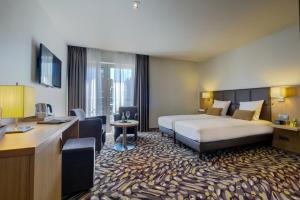 滑铁卢勒克特维赫特酒店的配有一张床和一张书桌的酒店客房