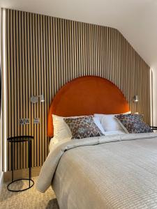 法灵登The Boutique Hotel的一间卧室配有一张大床和木制床头板