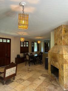 瓜拉米兰加Sítio riacho fundo的客厅设有石制壁炉和桌子。
