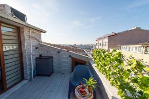 伊斯坦布尔Dach Wochnung mit Terrasse的阳台配有蓝色椅子和植物