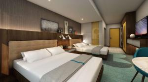 博伟公园Hilton Buena Park的酒店客房设有两张床和电视。