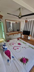 希曼杜岛White Sand Himandhoo的一间卧室,床上放着鲜花