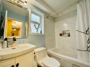 温哥华Private Guest Suite in Little Italy - King Bed - Free Parking - Central Location的浴室配有盥洗盆、卫生间和浴缸。