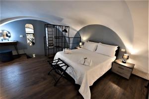 巴列塔San Giacomo Loft Apartment的卧室配有一张白色的大床和一张桌子