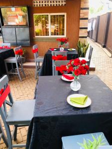 BusiaPals Inn的一张桌子,上面有红色的餐巾和鲜花