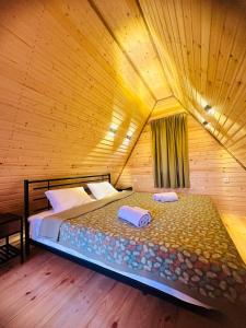 安布罗劳里Panorama Racha的木制客房内的一间卧室,配有一张床
