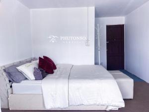 清迈Phutonso Homestay的卧室配有白色的床和枕头。