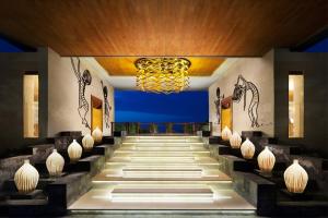 努沙杜瓦巴厘岛萨玛贝别墅酒店的酒店大堂设有吊灯和楼梯