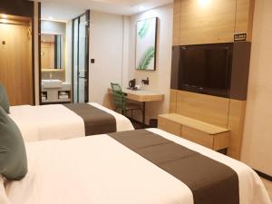 日喀则尚客优品日喀则扎什伦布寺酒店的酒店客房设有两张床和一台平面电视。
