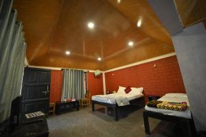 库斯哈尔纳加尔Coorg HomeStay Resort的一间卧室设有两张床和屋顶。