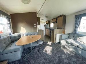 大雅茅斯Homely Dog Friendly Caravan At California Cliffs Holiday Park, Ref 50024j的客厅配有沙发和桌子