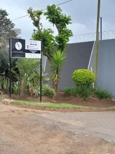 乌姆塔塔Adante Lodge & Conferencing的路旁有植物的标志