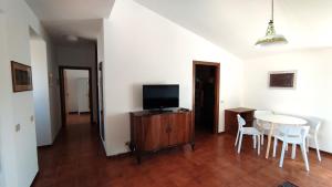 里米尼Al Ponte di Tiberio的客厅配有电视和桌椅