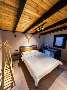 萨潘贾Mouna Sapanca的一间卧室设有一张大床和木制天花板
