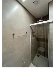 乌贝兰迪亚Flats Uberlândia的带淋浴的浴室和玻璃门