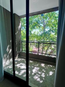 罗萨里奥Depto acogedor, moderno y espacioso的开放式玻璃门,享有阳台的景色
