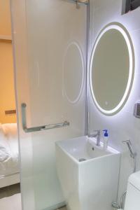 马累Fanfini Residence Male’的白色的浴室设有水槽和镜子