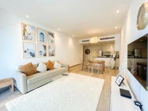 迪拜Deluxe 1 Bedroom Apartment - Elite Residence Dubai Marina - Sea View的带沙发的客厅和用餐室