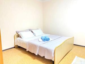 阿拉木图Town House, metro Raiymbek的一间卧室配有一张带2条蓝色毛巾的床