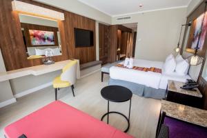 长滩岛Mandarin Bay Resort and Spa的大型酒店客房,配有一张床和一张书桌