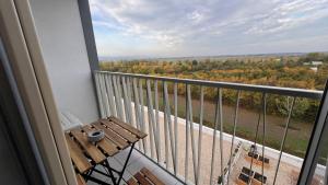 布拉迪斯拉发2 room Apartment with terrace, new building, 8BJ的阳台设有木凳,享有树林美景。