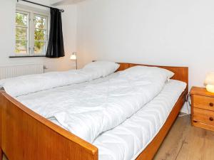齐斯泰兹Holiday home Thisted LVII的卧室内的一张带白色床单的大床