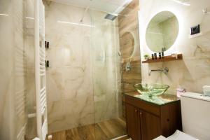 塞萨洛尼基Thessaloniki Amazing Apartment的一间带玻璃淋浴间和水槽的浴室