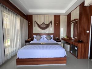 ToyapakehGrand Yuna Hotel Nusa Penida的一间卧室配有一张带木墙的大床