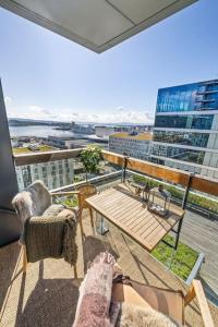 奥斯陆Modern 2bed room sea view apartment @ Oslo Barcode的市景阳台配有桌椅。