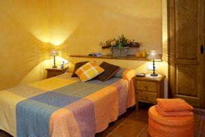 佩拉托拉达Turisme Rural Ca l,Anguila的一间卧室配有一张床、两盏灯和一张凳子