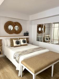 马贝拉EL PISITO SAND, a 700 metros del casco antiguo的一间卧室配有一张大床和两面镜子